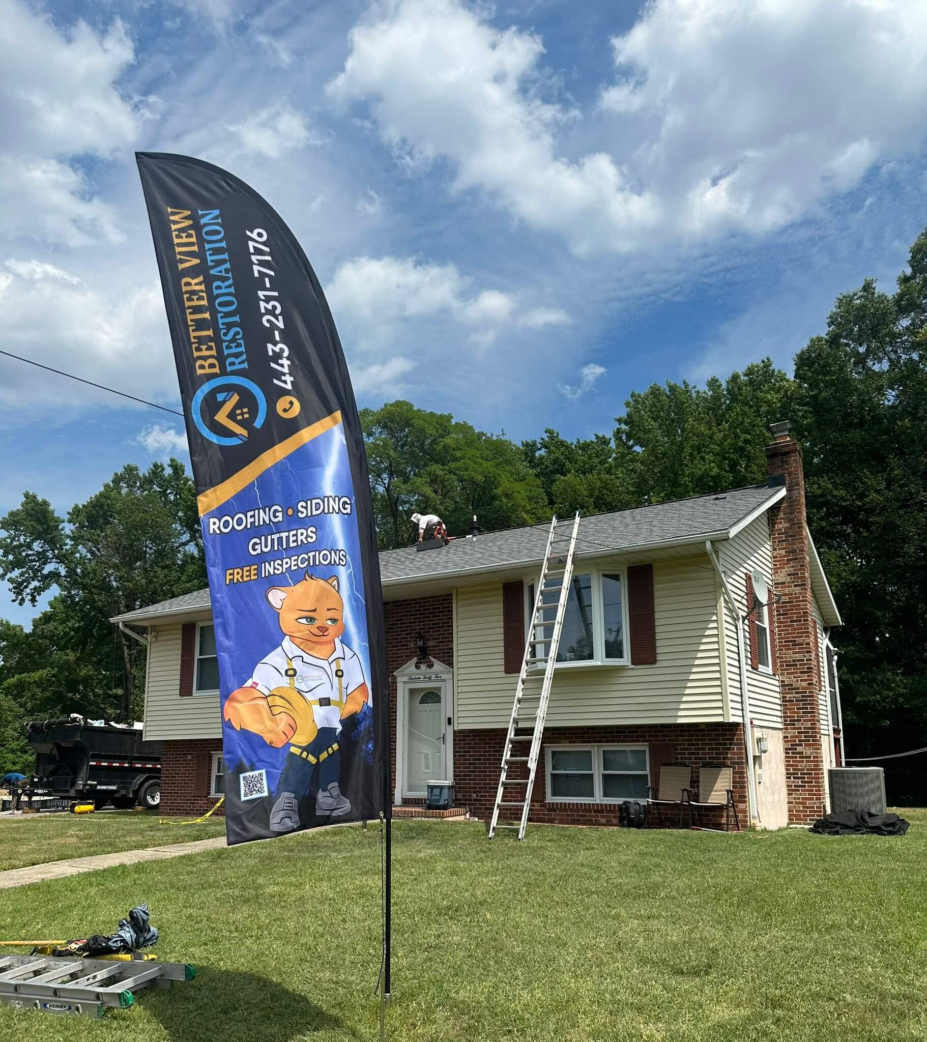 House restored by Better View Restoration with a professional banner highlighting roofing, siding, and gutter services.